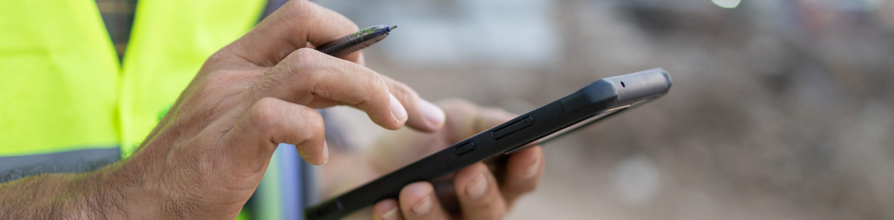 Close up construction worker holding pen touch screen using smar